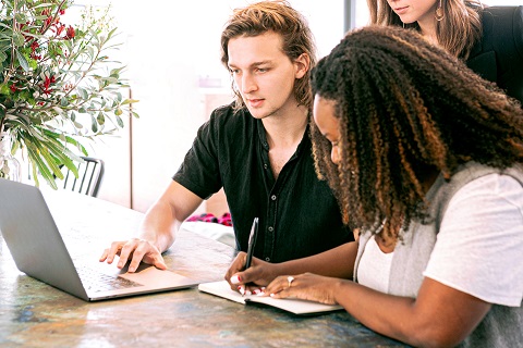 man-working-on-laptop-while-woman-takes-notes-3153199